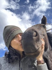 Alisa Hewitt taking a selfie while kissing her horse